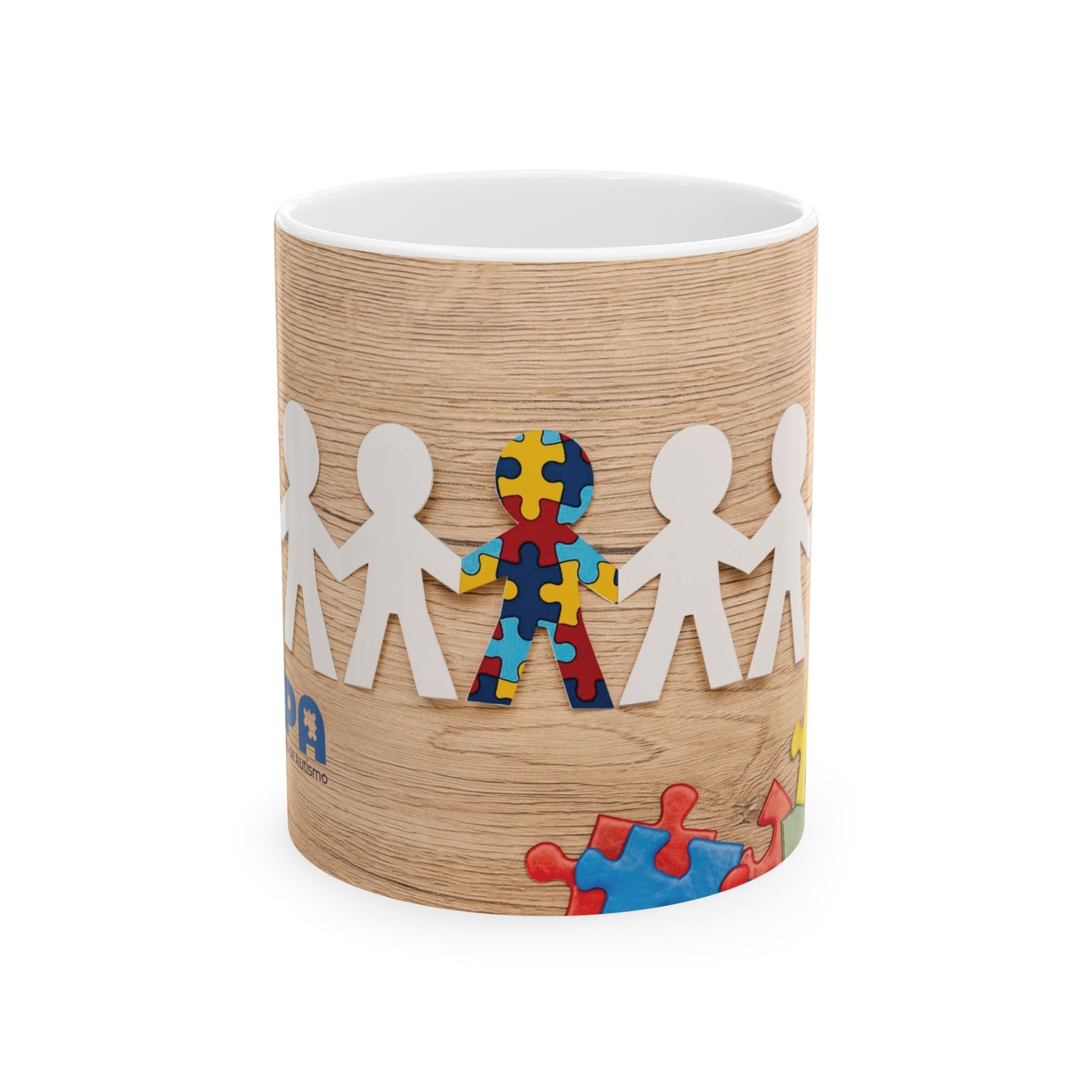 Puzzle Piece Ceramic Mug featuring colorful puzzle design representing diversity and inclusion on a wooden background.