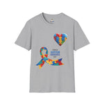 Gray t-shirt featuring a colorful heart made of puzzle pieces and a multicolored puzzle ribbon with the word “Autism,” symbolizing autism awareness, love, and inclusion.