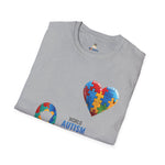 Folded Gray t-shirt featuring a colorful heart made of puzzle pieces with the word “Autism,” symbolizing autism awareness, love, and inclusion.