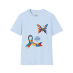 Light blue t-shirt featuring a colorful butterfly and multicolored puzzle ribbon design with the word “Autism,” symbolizing autism awareness and inclusion.