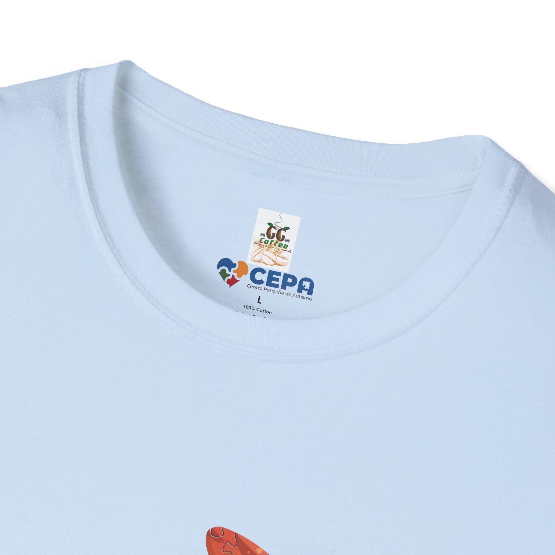 Close-up of a light blue t-shirt showing the GG Coffee Brew Co. and CEPA logo printed near the collar, representing support for autism awareness and inclusion.