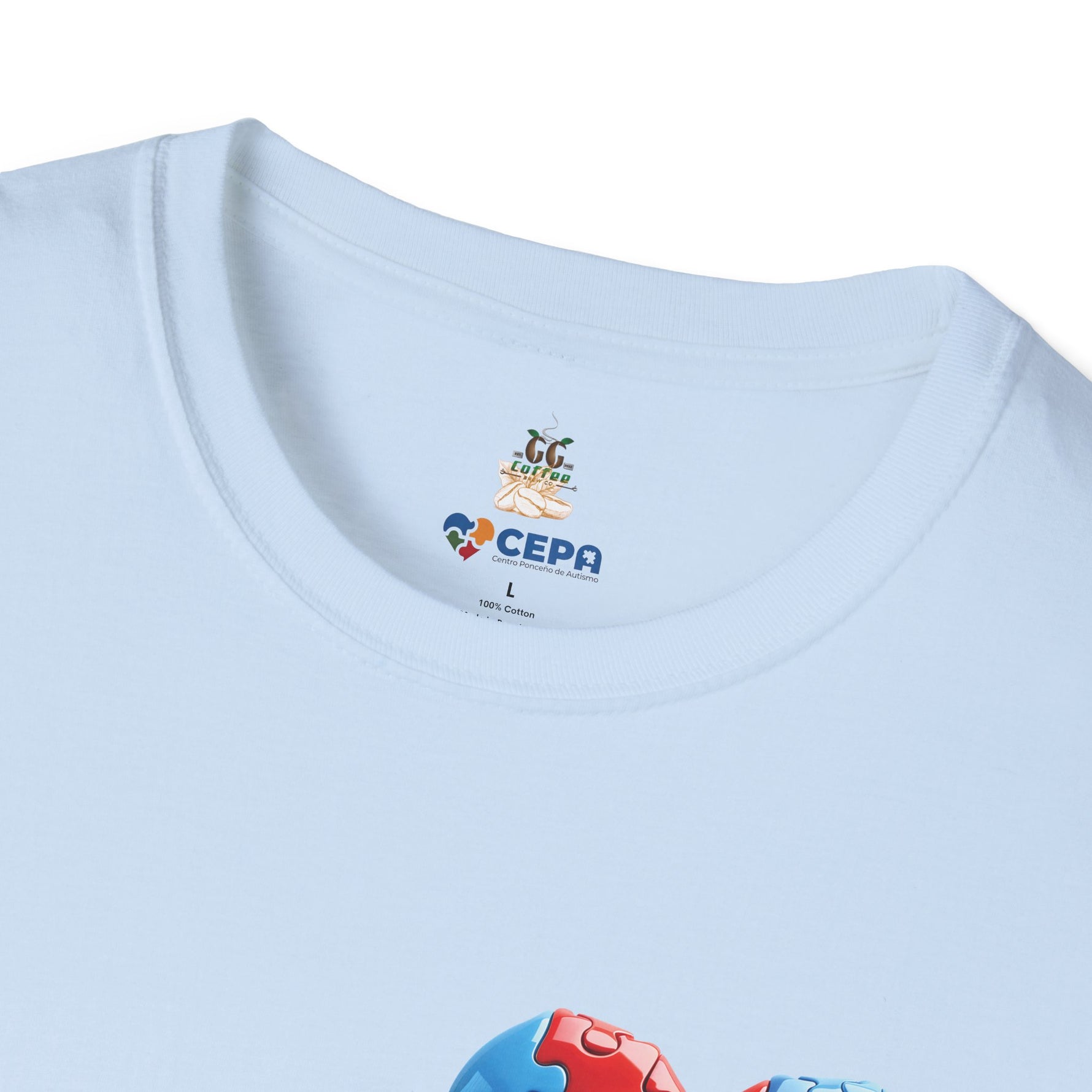 Close-up of a Light blue t-shirt showing the GG Coffee Brew Co. and CEPA logo near the collar, representing autism awareness and inclusion.