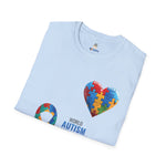 olded Light blue t-shirt featuring a colorful heart made of puzzle pieces with the word “Autism,” symbolizing autism awareness, love, and inclusion.