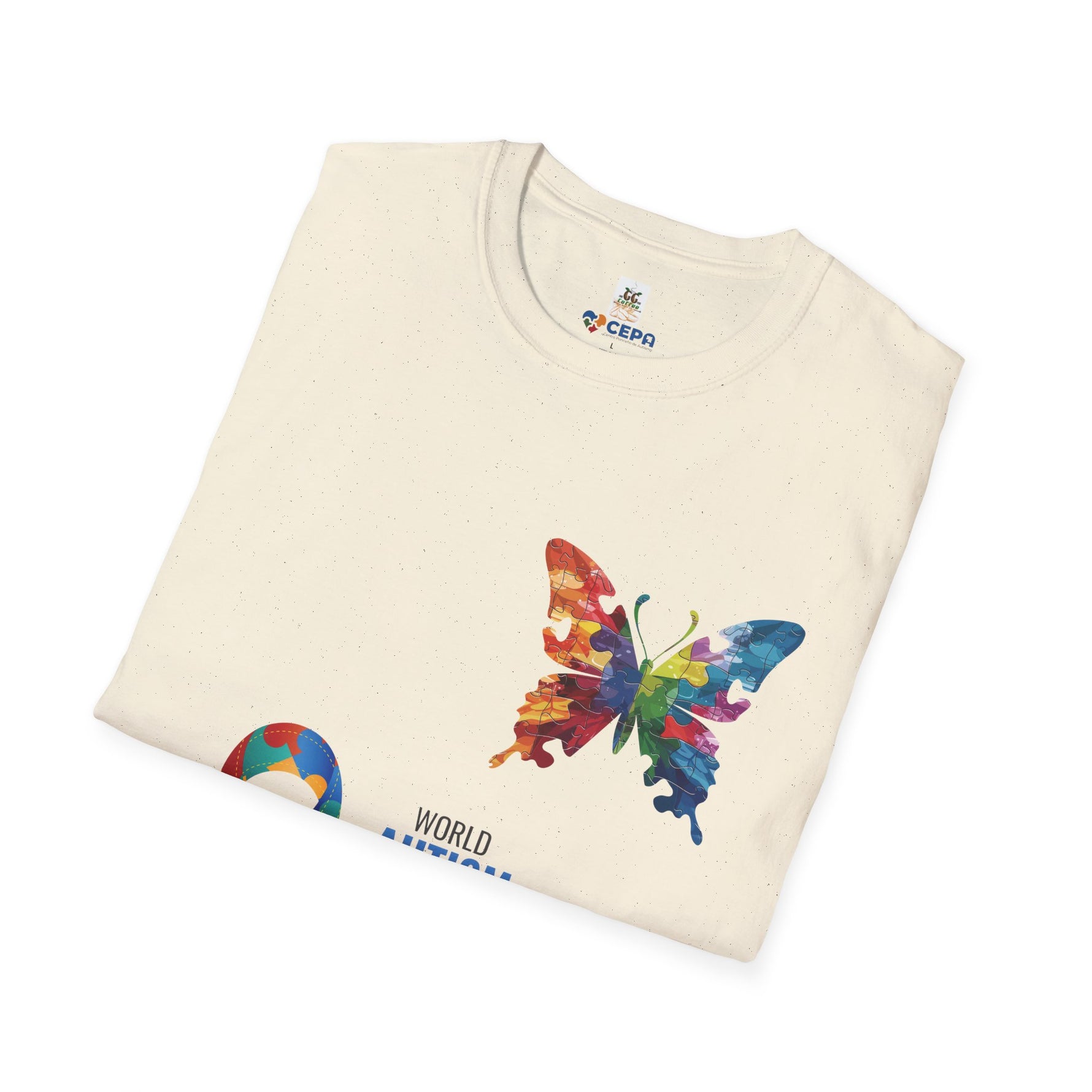 Natural t-shirt featuring a vibrant multicolored butterfly with puzzle patterns and the CEPA logo near the collar, symbolizing autism awareness and inclusion.