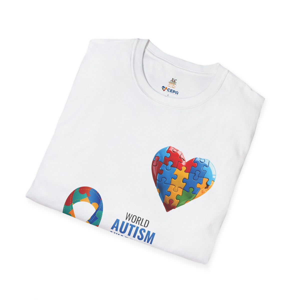 Folded White t-shirt featuring a colorful heart made of puzzle pieces with the word “Autism,” symbolizing autism awareness, love, and inclusion.