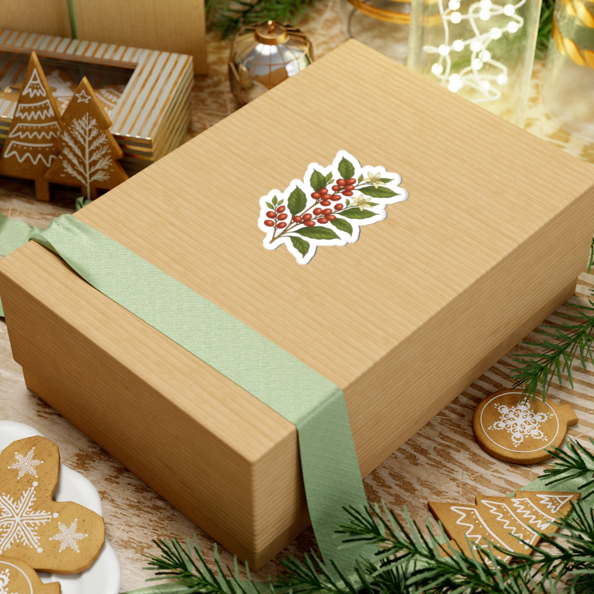 Gift box adorned with a botanical coffee plant sticker, showcasing chic holiday décor with greenery.