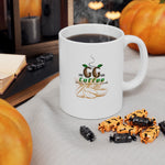Cozy ceramic coffee mug with coffee and charming design, surrounded by pumpkins and spooky decorations.
